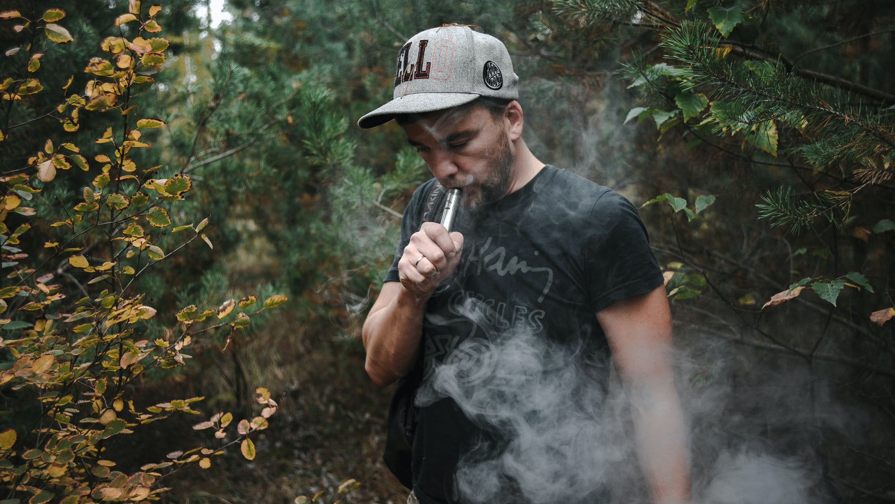 Man vaping in forest