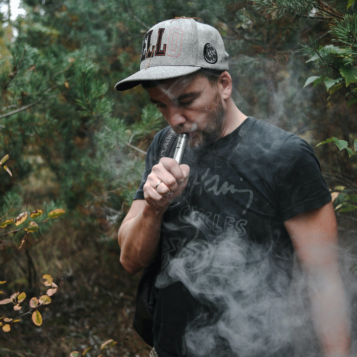 Man vaping in forest