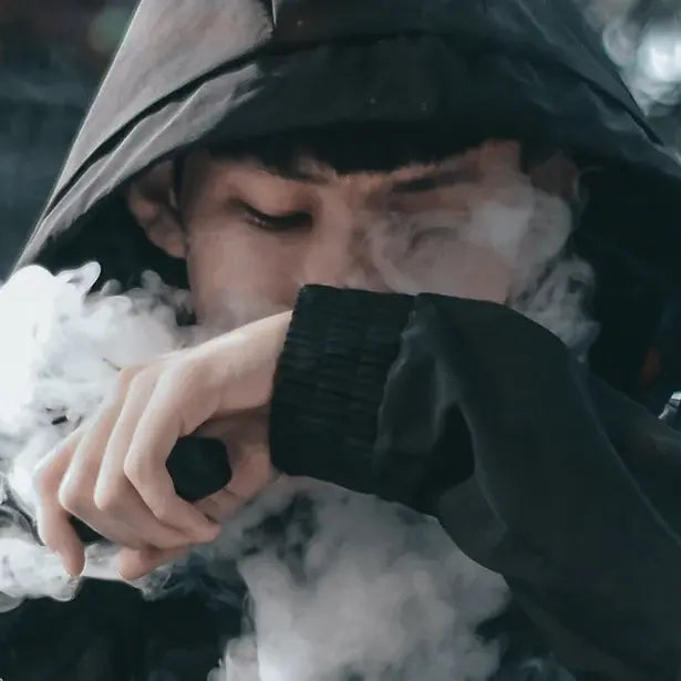 Man in hoodie vaping